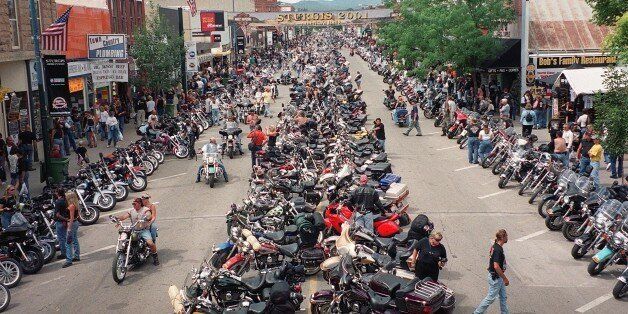 STURGIS, MI - AUGUST 14: Thousands of bikers crowd main street during the 61st annual motorcycle rally held 06-12 August, 2001 in Sturgis, South Dakota. Thousands of bikers from around the US travel to Sturgis to participate in one of the world's largest outdoor events. (Photo credit should read FRANCIS TEMMAN/AFP/Getty Images)
