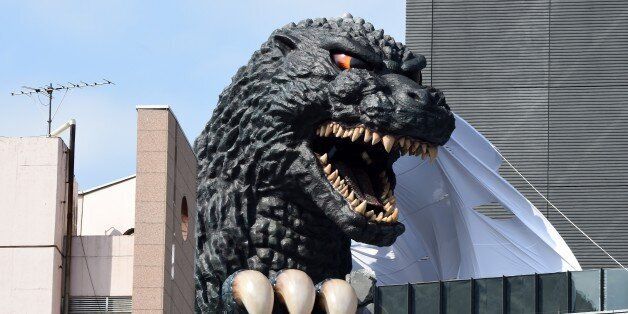 A life-size Godzilla head appears on a balcony of the eighth floor of Hotel Gracery Shinjuku at Kabukicho shopping district in Tokyo on April 9, 2015. The Godzilla is a main feature of the new commercial complex comprising a 970-room hotel, movie theathres and restaurants which will be open this month. AFP PHOTO / Toru YAMANAKA (Photo credit should read TORU YAMANAKA/AFP/Getty Images)