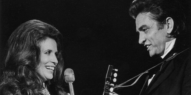 Married country singers Johnny Cash (1932 - 2003) and June Carter Cash (1929 - 2003) perform a duet on stage. (Photo by Archive Photos/Getty Images)