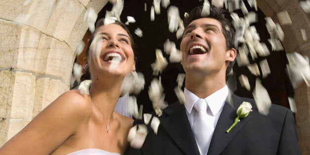 Flower petals over bride and groom