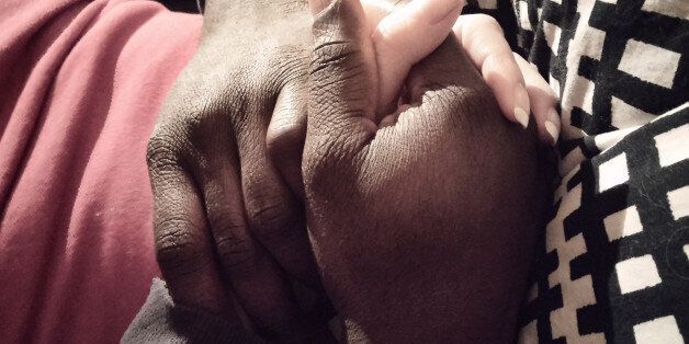 Interracial couple holding hands.