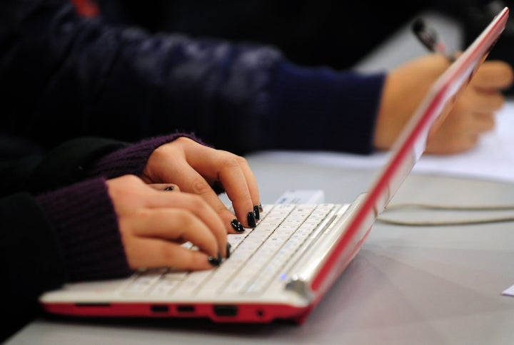 This photo taken on January 7, 2010 shows a woman typing on the keyboard of her laptop computer in Beijing. China declared its Internet 'open' on January 14 but defended censorship that has prompted Web giant Google to threaten to pull out of the country, sparking a potential new irritant in China-US relations. China employs a vast system of Web censorship dubbed the 'Great Firewall of China' that blocks content such as political dissent, pornography and other information viewed as objectionable and the issue looks likely to shape up as the latest addition to a growing list of disputes between China and the United States over trade, climate change and human rights. AFP PHOTO / Frederic J. BROWN (Photo credit should read FREDERIC J. BROWN/AFP/Getty Images)