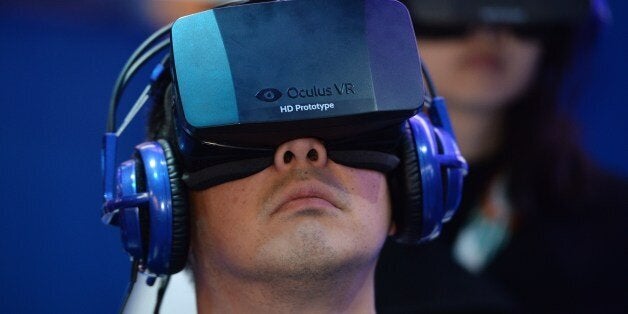 An attendee wears an Oculus Rift HD virtual reality head-mounted display at he plays EVE: Valkyrie, a multiplayer virtual reality dogfighting shooter game, at the Intel booth at the 2014 International CES, January 9, 2014 in Las Vegas, Nevada. AFP PHOTO /ROBYN BECK (Photo credit should read ROBYN BECK/AFP/Getty Images)