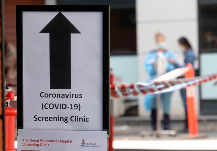 Hospital nursing staff assist people lining up for COVID-19 screening outside the Royal Melbourne Hospital on March 11 in Melbourne, Australia.