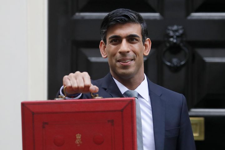 Rishi Sunak stands outside No 11 Downing Street and holds up the traditional red box that contains the budget speech for the media.
