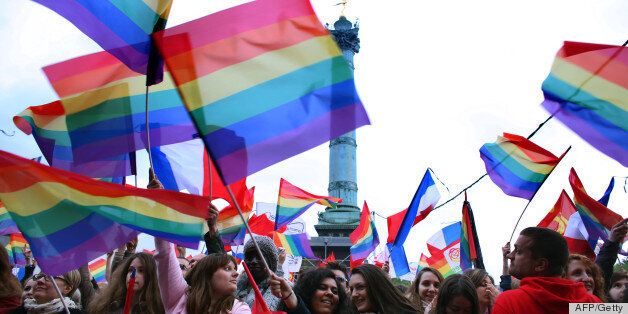 People holding rainbow flags attend the event 'Concert pour tous!' (Concert for all!) on May 21, 2013 at the Bastille square in Paris. The 'Concert for all!' in reference of the French anti-gay marriage movement 'Manif pour tous !' (Demonstration for all!), is held to celebrate the legalisation of same-sex marriage. After months of acrimonious debate and hundreds of protests that have occasionally spilled over into violence, France's National Assembly approved on April 23, 2013 a bill making the country the 14th to legalise same-sex marriage. AFP PHOTO / THOMAS SAMSON (Photo credit should read THOMAS SAMSON/AFP/Getty Images)