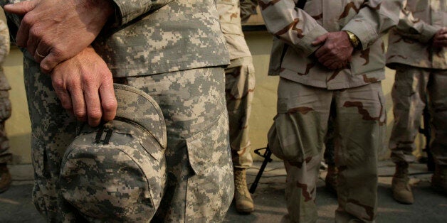 U.S soldiers pray at a war memorial during a Veterans Day ceremony at Camp Eggers Kabul, Afghanistan, Sunday, Nov. 11, 2007. U.S. soldiers in Afghanistan marked the Veterans Day by offering veterans memorial meditation and prayer for the fallen colleagues in Afghanistan.(AP Photo/Rafiq Maqbool)