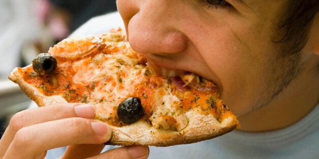 Teenage Boy (15-17) Eating Pizza, Close-Up