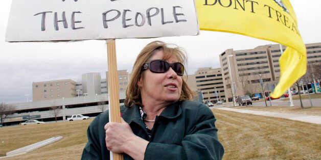 ROYAL OAK, MI - MARCH 22: Janice Daniels of Troy, Michigan, one of the founders of the Troy Tea Party, attends a rally for a ballot initiative opposing the new federal health care bill March 22, 2010 in Royal Oak, Michigan. The initiative, sponsored by Michigan State Representative Tom McMillin, is designed to get the State of Michigan exempted from the new health care bill. (Photo by Bill Pugliano/Getty Images)