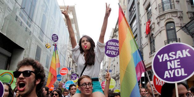 People march and chant slogans during a gay parade on Istiklal Street, the main shopping corridor on June 30, 2013 in Istanbul during the fourth Trans Pride Parade as part of the Trans Pride Week 2013, which is organized by Istanbul's 'Lesbians, Gays, Bisexuals, Transvestites and Transsexuals' (LGBTT) solidarity organization. AFP PHOTO/GURCAN OZTURK (Photo credit should read GURCAN OZTURK/AFP/Getty Images)