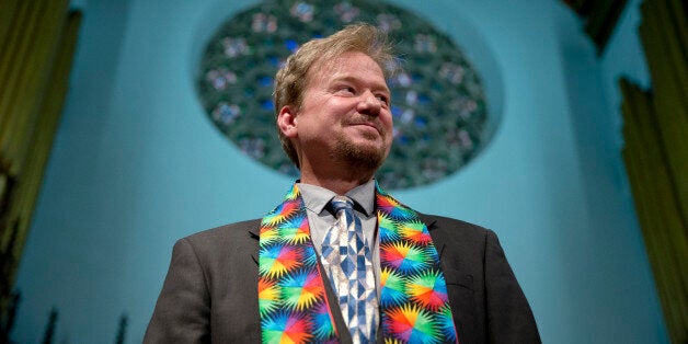 United Methodist pastor Frank Schaefer, right, hugs the Rev. David Wesley Brown after a news conference Tuesday, June 24, 2014, at First United Methodist Church of Germantown in Philadelphia. Schaefer, who presided over his son's same-sex wedding ceremony and vowed to perform other gay marriages if asked, can return to the pulpit after a United Methodist Church appeals panel on Tuesday overturned a decision to defrock him. (AP Photo/Matt Rourke)