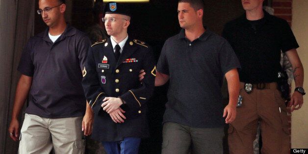FORT MEADE, MD - JULY 25: U.S. Army Private First Class Bradley Manning (2nd L) is escorted by military police as he leaves after the first day of closing arguments in his military trial July 25, 2013 Fort George G. Meade, Maryland. Manning, who is charged with aiding the enemy and wrongfully causing intelligence to be published on the internet, is accused of sending hundreds of thousands of classified Iraq and Afghanistan war logs and more than 250,000 diplomatic cables to the website WikiLeaks while he was working as an intelligence analyst in Baghdad in 2009 and 2010. (Photo by Chip Somodevilla/Getty Images)