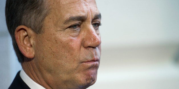 Speaker of the House John Boehner, R-Ohio, listens as house republican leadership speaks with the press after a House Republican meeting on Capitol Hill in Washington, DC, October 15, 2013. With the government shutdown going into day fifteen and the deadline for raising the debt ceiling fast approaching, Democrats and Republicans are working to come to an agreement soon on passing a budget. AFP PHOTO / Jim WATSON (Photo credit should read JIM WATSON/AFP/Getty Images)