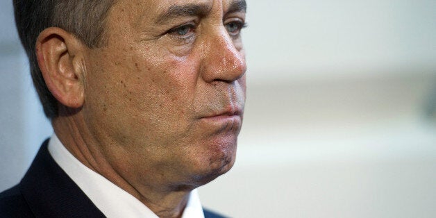 Speaker of the House John Boehner, R-Ohio, listens as house republican leadership speaks with the press after a House Republican meeting on Capitol Hill in Washington, DC, October 15, 2013. With the government shutdown going into day fifteen and the deadline for raising the debt ceiling fast approaching, Democrats and Republicans are working to come to an agreement soon on passing a budget. AFP PHOTO / Jim WATSON (Photo credit should read JIM WATSON/AFP/Getty Images)