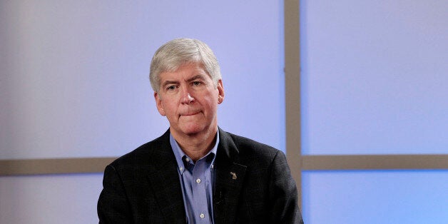 Rick Snyder, governor of Michigan, listens at a public meeting in Detroit, Michigan, U.S., on Friday, March 1, 2013. Snyder said he plans to name an emergency manager to handle Detroit?s fiscal crisis, stripping power from local officials in a withered city that in 1940 was the fourth biggest in the U.S. and a thriving capital of industry. Photographer: Jeff Kowalsky/Bloomberg via Getty Images