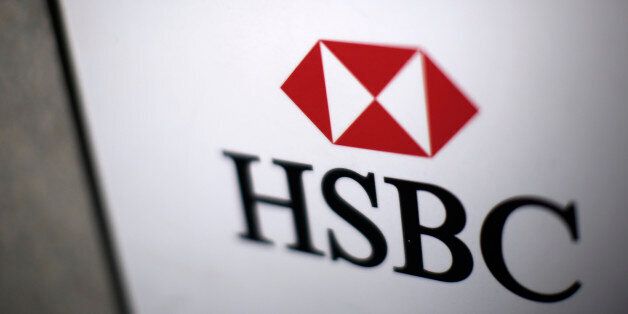 A logo sits on a sign outside a HSBC Holdings Plc bank branch in London, U.K., on Monday, Dec. 9, 2013. HSBC may sell a stake in its U.K. retail and commercial bank on the stock exchange to ease the effect of new regulations, the Financial Times newspaper reported. Photographer: Matthew Lloyd/Bloomberg via Getty Images