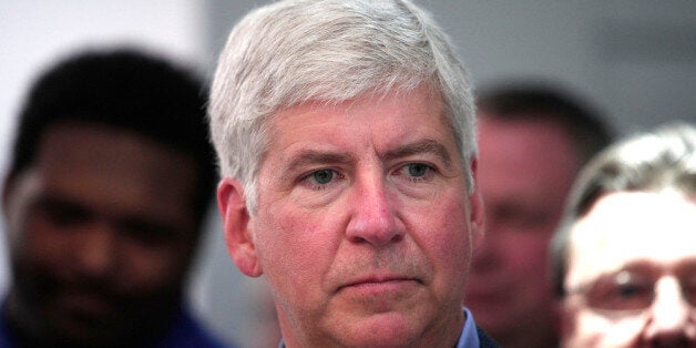 DETROIT, MI - JANUARY 14: Michigan Gov. Rick Snyder visits the Denso display to talk about Michigan and automatic vehicle technology at the press preview of the 2014 North American International Auto Show January 14, 2014 in Detroit, Michigan. Approximately 5000 journalists from more than 60 countries are expected to attend. The 2014 NAIAS opens to the public on January 18th and ends January 16th. (Photo by Bill Pugliano/Getty Images)