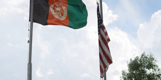 NANGALAM, AFGHANISTAN - JUNE 13: The Afghan flag flies alongside the stars and stripes on Nangalam base on June 13, 2012 in the Pech Valley, Afghanistan. As the NATO draw-down gathers pace in eastern Afghanistan, the Afghan National Army have voiced concern that without US re-supply, they won't be able to secure the region against insurgents. (Photo by John Cantlie/Getty Images)