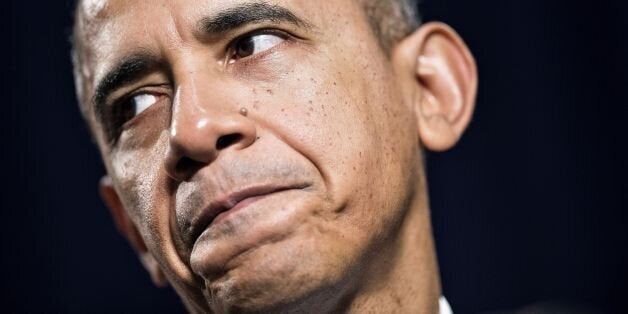 US President Barack Obama pauses while speaking during the Democratic Issues Conference February 14, 2014 in Cambridge, Maryl