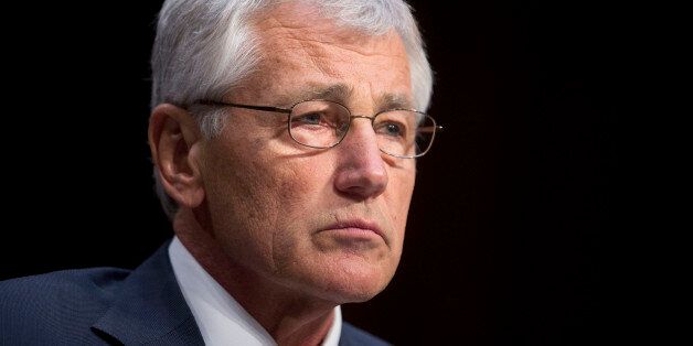 Chuck Hagel, U.S. secretary of defense, listens during a Senate Armed Services Committee hearing in Washington, D.C., U.S., on Wednesday, March 5, 2014. Hagel told Congress that he will propose budgets in coming years that exceed mandated spending caps in order to avoid compromising national security. Photographer: Andrew Harrer/Bloomberg via Getty Images 