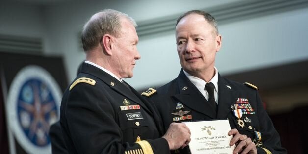 Chairman of the Join Chief of Staff Army General Martin Dempsey (L) presents General Keith B. Alexander with a certificate after awarding him with the Defense Distinguished Service Medal during a retirement ceremony at the National Security Agency March 28, 2014 in Fort Meade, Maryland. US Secretary of Defense Chuck Hagel attended the event to mark the retirement of General Keith B. Alexander from the US Army and as head of the National Security Agency, the Central Security Service and U.S. Cyber Command. AFP PHOTO/Brendan SMIALOWSKI (Photo credit should read BRENDAN SMIALOWSKI/AFP/Getty Images)