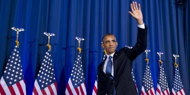 US President Barack Obama waves after speaking about his administration's drone and counterterrorism policies, as well as the military prison at Guantanamo Bay, at the National Defense University in Washington, DC, May 23, 2013. An anti-war heckler repeatedly interrupted President Barack Obama in a major speech on reframing US counter-terrorism policy Thursday, prompting him to depart from his prepared remarks. 'The voice of that woman is worth paying attention to -- obviously I don't agree with much of what she said,' Obama said, after repeatedly asking the woman to sit down. 'She wasn't listening to me, in what I said -- but these are tough issues and the suggestion that we can gloss over them is wrong,' Obama said. AFP PHOTO / Saul LOEB (Photo credit should read SAUL LOEB/AFP/Getty Images)