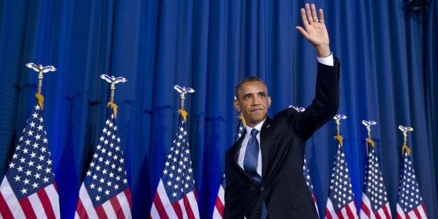 US President Barack Obama waves after speaking about his administration's drone and counterterrorism policies, as well as the military prison at Guantanamo Bay, at the National Defense University in Washington, DC, May 23, 2013. An anti-war heckler repeatedly interrupted President Barack Obama in a major speech on reframing US counter-terrorism policy Thursday, prompting him to depart from his prepared remarks. 'The voice of that woman is worth paying attention to -- obviously I don't agree with much of what she said,' Obama said, after repeatedly asking the woman to sit down. 'She wasn't listening to me, in what I said -- but these are tough issues and the suggestion that we can gloss over them is wrong,' Obama said. AFP PHOTO / Saul LOEB (Photo credit should read SAUL LOEB/AFP/Getty Images)