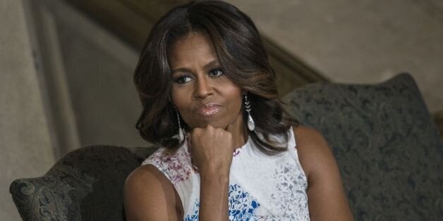 US first lady Michelle Obama listens during a naturalization ceremony at the National Archives June 18, 2014 in Washington, D