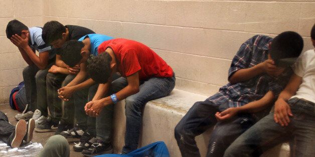 MCALLEN, TX - JULY 15: Immigrants who have been caught crossing the border illegally are housed inside the McAllen Border Patrol Station in McAllen, Texas where they are processed on July 15, 2014 in McAllen, Texas. The detainees are both men and women, and range in age from infants to adults, where more than 350 were being held. Detainees are mostly separated by gender and age, except for infants. More than 57,000 unaccompanied children have been apprehended at the southwestern border since October, more than twice the total this time last year, many through the Rio Grande Valley. Many are fleeing growing violence in Central America. (Pool photo by Rick Loomis-Pool/Getty Images)