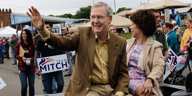 FOUNTAIN RUN, KY - MAY 17: Senate Minority Leader Sen. Mitch McConnell rides in the Fountain Run BBQ Festival parade with his wife Elaine Chao while campaigning for the Republcian primary May 17, 2014 in Fountain Run, Kentucky. McConnell and challenger Matt Bevin are campaigning heavily throughout the state during the final weekend before the primary to be held May 20. (Photo by Win McNamee/Getty Images)