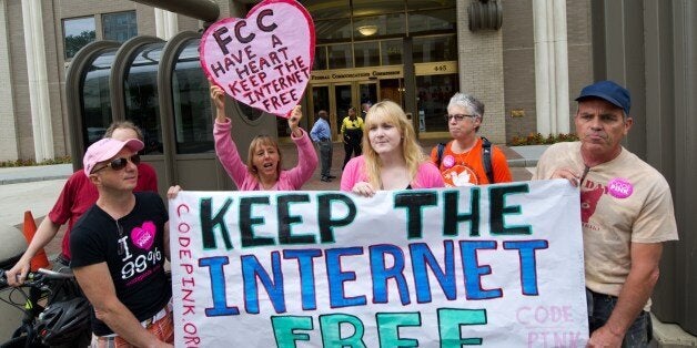 Protesters hold a rally to support 'net neutrality' and urge the Federal Communications Commission (FCC) to reject a proposal that would allow Internet service providers such as AT&T and Verizon 'to boost their revenue by creating speedy online lanes for deep-pocketed websites and applications and slowing down everyone else,' on May 15, 2014 at the FCC in Washington, DC. The FCC commissioners voted on a proposal for protecting an open Internet. AFP PHOTO / Karen BLEIER (Photo credit should read KAREN BLEIER/AFP/Getty Images)