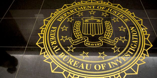 The seal of the Federal Bureau of Investigation is seen on the floor at the FBI's Washington field office in Washington, D.C., U.S., on Thursday, March 13, 2014. The FBI joined Malaysia's inquiry into the missing jet as authorities sought to retrieve deleted data on a computer flight simulator belonging to the planeÃs pilot. Photographer: Andrew Harrer/Bloomberg via Getty Images