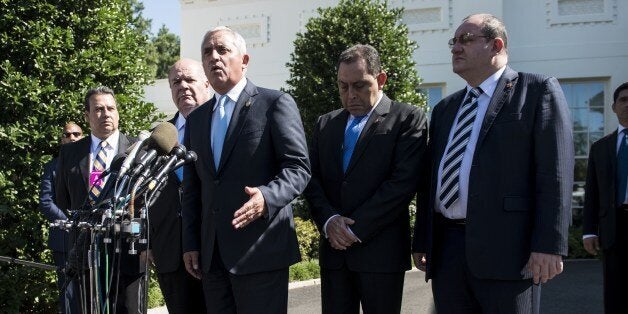 Guatemalan President Otto Perez Molina speaks to the press outside the West Wing after a meeting at the White House on July 25, 2014 in Washington. US President Barack Obama met with his counterparts from Guatemala, Honduras and El Salvador to speak about the number of immigrants, specifically children, leaving the Central American region for other countries including the United States. AFP PHOTO/Brendan SMIALOWSKI (Photo credit should read BRENDAN SMIALOWSKI/AFP/Getty Images)