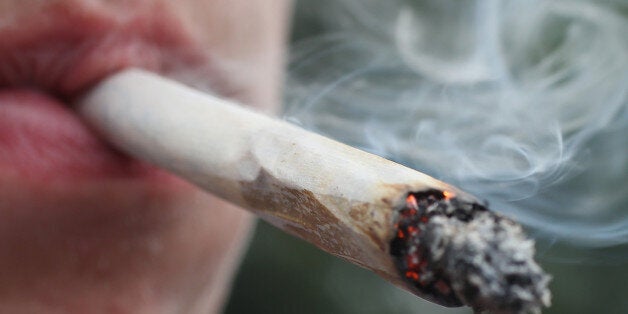 BERLIN, GERMANY - AUGUST 09: A participant smokes a marijuana joint while marching in the annual Hemp Parade (Hanfparade) on