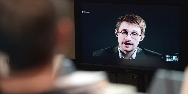 US National Security Agency (NSA) whistleblower Edward Snowden speaks to European officials via videoconference during a parliamentary hearing on improving the protection of whistleblowers, at the Council of Europe in Strasbourg, eastern France, on June 24, 2014. AFP PHOTO/FREDERICK FLORIN (Photo credit should read FREDERICK FLORIN/AFP/Getty Images)