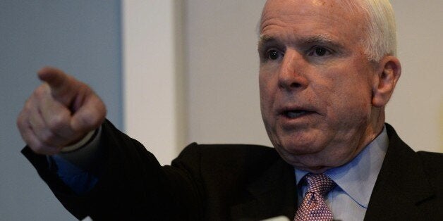 US senator John McCain takes questions during a press conference held jointly with US senator Sheldon Whitehouse (not pictured) in Hanoi on August 8, 2014. The senators held talks with Vietnams top leaders on bilateral, regional security and human rights issues. AFP PHOTO/HOANG DINH Nam (Photo credit should read HOANG DINH NAM/AFP/Getty Images)