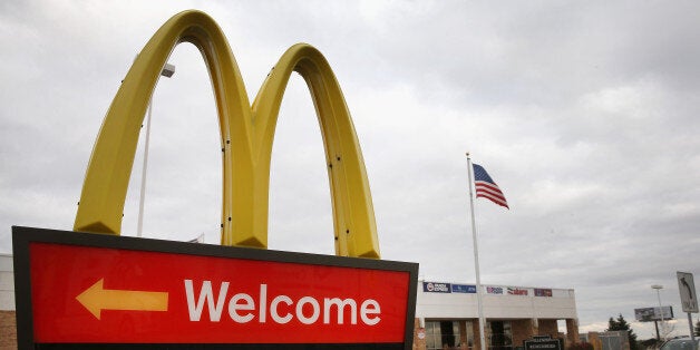 DES PLAINES, IL - OCTOBER 24: A sign directs customers to the drive-thru at a McDonald's restaurant on October 24, 2013 in Des Plaines, Illinois. McDonald's has announced it will make changes to its low-priced Dollar Menu, which includes items like coffee, small fries, hamburgers and apple pies. The new menu, dubbed the Dollar Menu and More, will offer some higher priced options such as the grilled Onion Cheddar Burger and a McChicken sandwich. (Photo by Scott Olson/Getty Images)