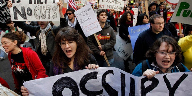 Protesters from the Occupy Boston movement, students from area colleges, and union workers chant slogans and display placards as they march through downtown Boston, Wednesday, Nov. 2, 2011. The march was held to protest the nations growing student debt burden. (AP Photo/Steven Senne)