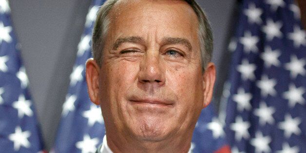 House Speaker John Boehner of Ohio gives a wink to a reporter as he answers questions with GOP leaders at Republican National Committee headquarters on Capitol Hill in Washington, Tuesday, July 15, 2014. (AP Photo/J. Scott Applewhite)