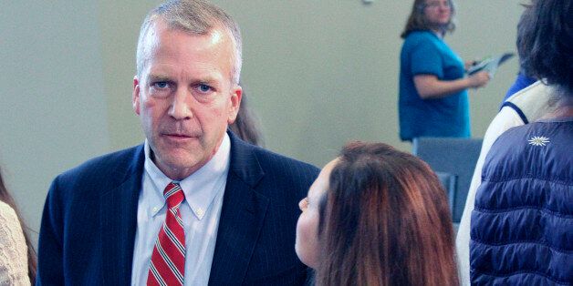 FILE - In this Aug. 4, 2014 file photo, Dan Sullivan, Republican candidate for U.S. Senator, left, speaks with supporters following a debate in Eagle River, Alaska. Television ads in Alaska's U.S. Senate race have been pulled by the two major party candidates after complaints from the family of two slaying victims, Tuesday, Sept. 2, 2014.U.S. Sen. Mark Begich, D-Alaska, began airing an ad last week trying to portray his Republican opponent, former Alaska Attorney General Dan Sullivan, as soft on crime. Sullivan swiftly responded with an ad of his own, accusing Begich of trying to use the case for political gain. (AP Photo/Mark Thiessen, File)