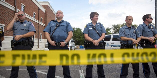 FERGUSON, MO - AUGUST 30: Police stand guard during a rally for Michael Brown outside the Ferguson Police Department August 30, 2014 in Ferguson, Missouri. Michael Brown, an 18-year-old unarmed teenager, was shot and killed by Ferguson Police Officer Darren Wilson on August 9. His death caused several days of violent protests along with rioting and looting in Ferguson. (Photo by Aaron P. Bernstein/Getty Images)
