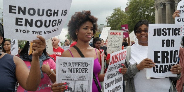 NEW YORK, UNITED STATES - AUGUST 24: People gather to protest the killing of Eric Garner in New York, United States, on August 24, 2014. Garner, 43, died on July 17 as cops tried to cuff him for allegedly selling bootleg cigarettes on a Staten Island sidewalk. (Photo by Selcuk Acar/Anadolu Agency/Getty Images)