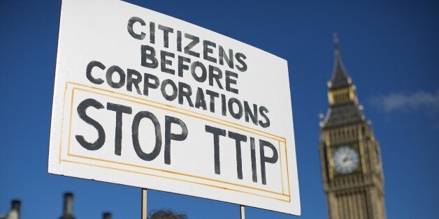 A woman demonstrates in central London on October 11, 2014, against the proposed Transatlantic Trade and Investment Partnership (TTIP). Brussels released the playbook for its talks with Washington on a giant EU-US trade deal on Thursday, saying it wanted to be transparent about a pact that has been criticised for favouring big business. AFP PHOTO / JUSTIN TALLIS (Photo credit should read JUSTIN TALLIS/AFP/Getty Images)