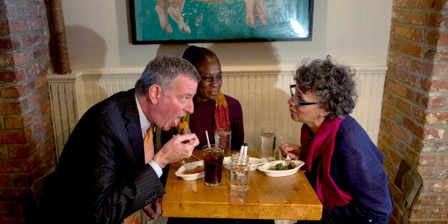 From left, New York City Mayor Bill de Blasio, wife Chirlane McCray, and New York City Health Commissioner Dr. Mary Bassett have a meal at The Meatball Shop in New York, Saturday, Oct. 25, 2014, where Dr. Craig Spencer, an Ebola patient, ate just before he became ill. Spencer remained in stable condition while isolated in a hospital, talking by cellphone to his family and assisting disease detectives who are accounting for his every movement since arriving in New York from Guinea via Europe on Oct. 17. (AP Photo/Craig Ruttle)