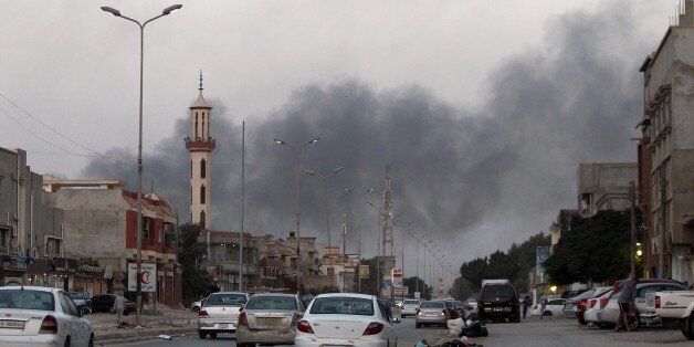 Smoke billows from buildings during clashes between Libyan security forces and armed Islamist groups in the eastern coastal city of Benghazi on August 23, 2014. Islamist fighters in the Fajr Libya (Libyan Dawn) coalition said they have captured Tripoli's battered international airport after many days of clashes with nationalist militiamen. AFP PHOTO / ABDULLAH DOMA (Photo credit should read ABDULLAH DOMA/AFP/Getty Images)