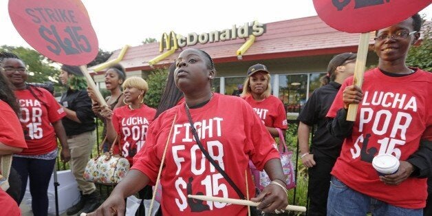 FILE - In this Sept. 14, 2014 file photo, protesters participate in a rally outside a McDonaldâs on Chicago's south side as labor organizers escalate their campaign raise the minimum wage for employees to $15 an hour. As Democrats across the country make an election-year push to raise the minimum wage, they are also looking to motivate younger people, minorities and others in their base to go to the polls on Nov. 4th. The party has put questions on the ballot in five states asking voters whether the minimum wage should be increased. (AP Photo/M. Spencer Green, File)