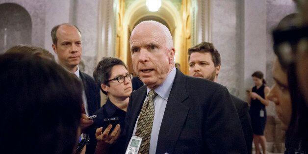 Sen. John McCain, R-Ariz., speaks to reporters as he leaves the Senate chamber after a roll call vote, at the Capitol in Washington, Wednesday, Nov. 12, 2014. Congress returns to work for the lame duck session today following a sweep for the GOP in the midterm elections that will shift the balance of power in January, giving Republicans control of the Senate with Sen. Mitch McConnell, R-Ky., taking over as majority leader. (AP Photo/J. Scott Applewhite)