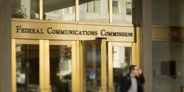 A man walks out of the Federal Communications Commission (FCC) headquarters in this photo taken with a tilt-shift lens in Washington, D.C., U.S., on Monday, Nov. 10, 2014. President Barack Obama called for the 'strongest possible rules' to protect the open Internet, advocating stricter controls than a regulator he appointed and causing shares of Comcast Corp. and other broadband providers to drop. Obama's comments tilt the White House against positions advocated by broadband providers and FCC Chairman Tom Wheeler. Photographer: Andrew Harrer/Bloomberg via Getty Images