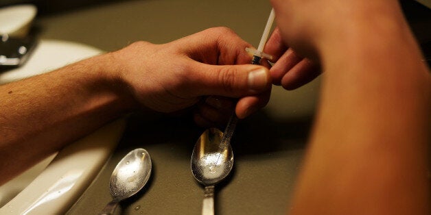 ST. JOHNSBURY, VT - FEBRUARY 06: Drugs are prepared to shoot intravenously by a user addicted to heroin on February 6, 2014