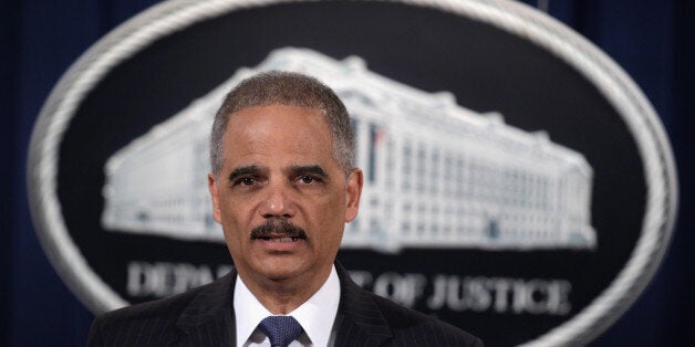 WASHINGTON, DC - FEBRUARY 03: U.S. Attorney General Eric Holder speaks during a news conference to make a major financial fraud announcement February 3, 2015 at the Justice Department in Washington, DC. Rating agency S&P has agreed to pay a $1.37 billion fine to settle charges from the Justice Department and 19 state attorneys general and the District of Columbia 'to resolve allegations that S&P had engaged in a scheme to defraud investors in structured financial products known as Residential Mortgage-Backed Securities (RMBS) and Collateralized Debt Obligations (CDOs).' (Photo by Alex Wong/Getty Images)